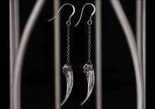 silver claw earrings displayed in a bird cage