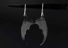 bat wing silver earrings on a black background