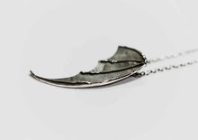 bat wing silver pendant on a white background