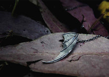 bat wing silver pendant on a leaf