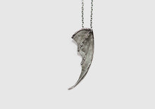 bat wing silver pendant on a white background